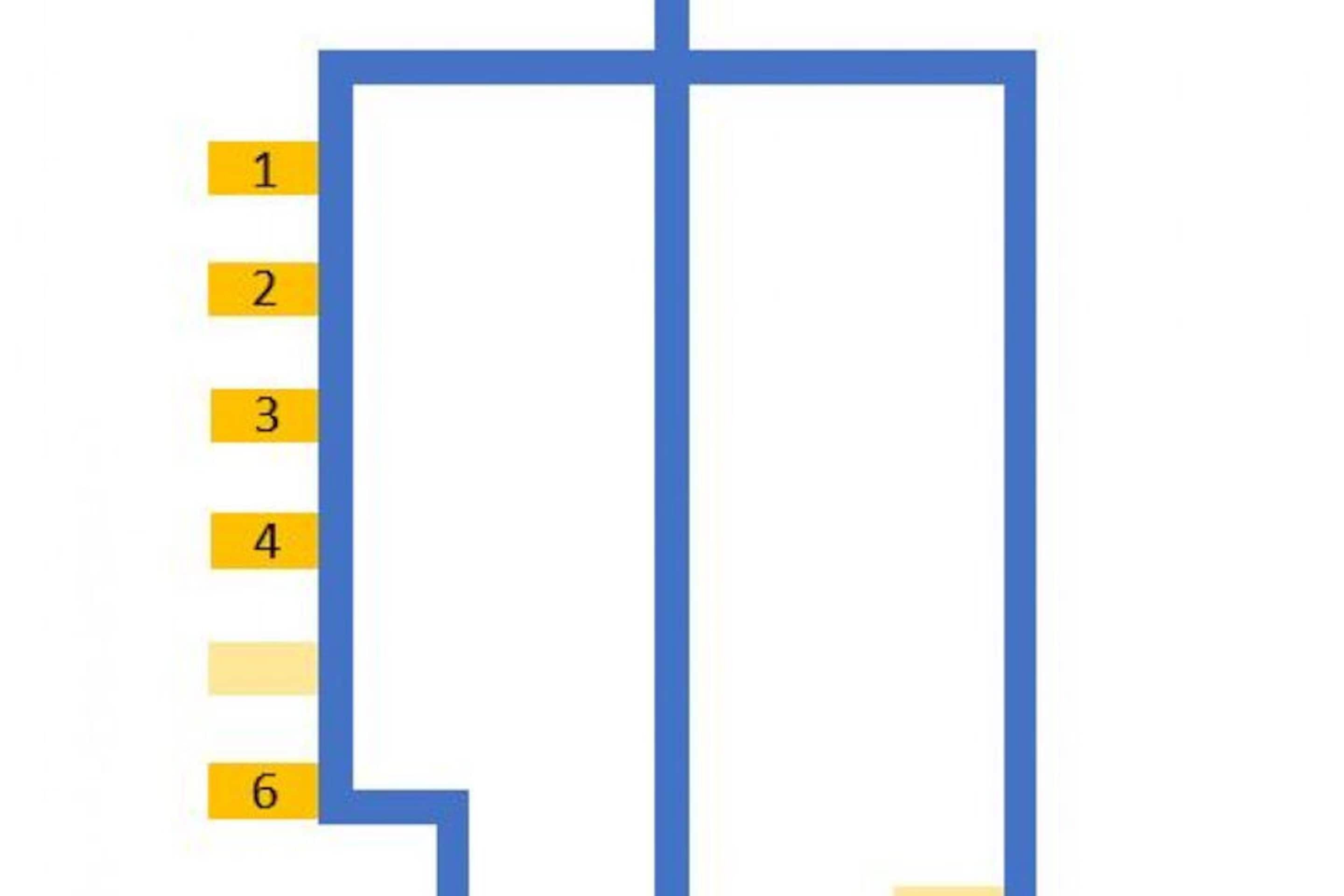 A hotel room layout with a bed, a desk, and a chair.
