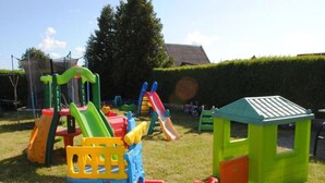 A playground with various play structures including slides and climbing frames. - Two-story Holiday Homes With Terraces (Mielno)