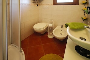 A bathroom with a toilet, bidet, sink, and a window. - Holiday Home With Above-ground Pool and sea View in Monteggiori (Camaiore)