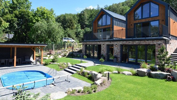 A modern two-story house with a swimming pool, outdoor seating, and a well-maintained garden. - Holiday Home With Pool and Sauna (Chmielno)
