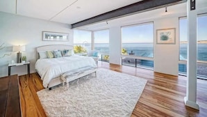 A modern bedroom with a large bed, a view of the ocean, and a balcony. - Spectacular La Jolla Cove Compound (San Diego)