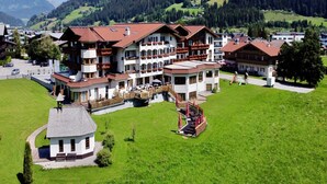 A large hotel with multiple floors, balconies, and a central courtyard with a playground. - Apartment House Isegrim, Altenmarkt (Altenmarkt im Pongau)