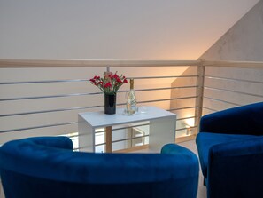 Relax with a drink on the balcony, where a small table and two comfortable chairs invite socializing and relaxation.