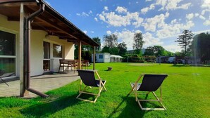 A covered patio area with two lawn chairs, a table, and a bench. - One-story House With a Terrace, Kolobrzeg (Kolobrzeg)