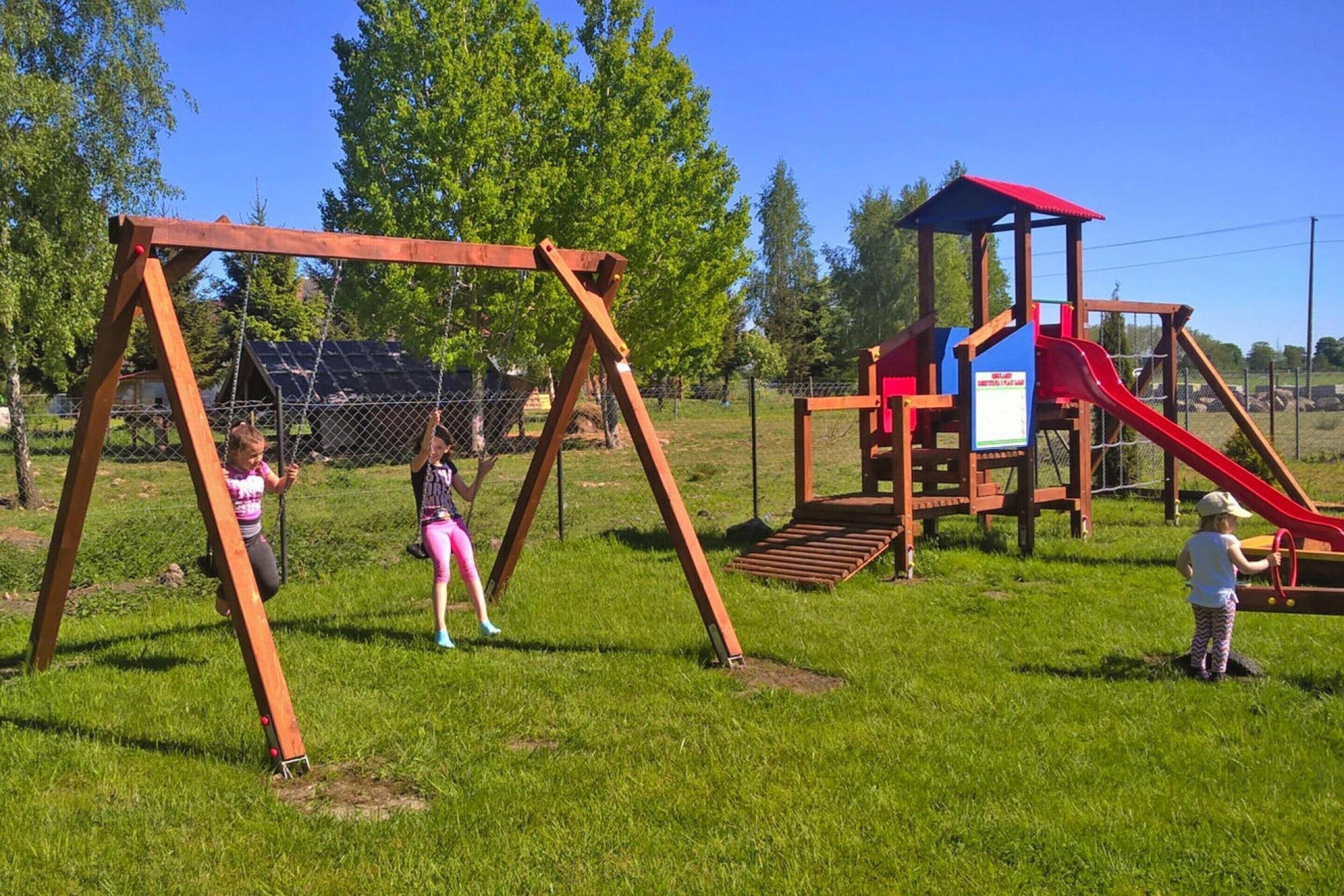 A playground with swings and a slide.