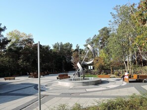 A public park with a central sculpture, benches, and trees. - Holiday Home Near Baltic Sea and Nature Reserve (Kamien Pomorski)