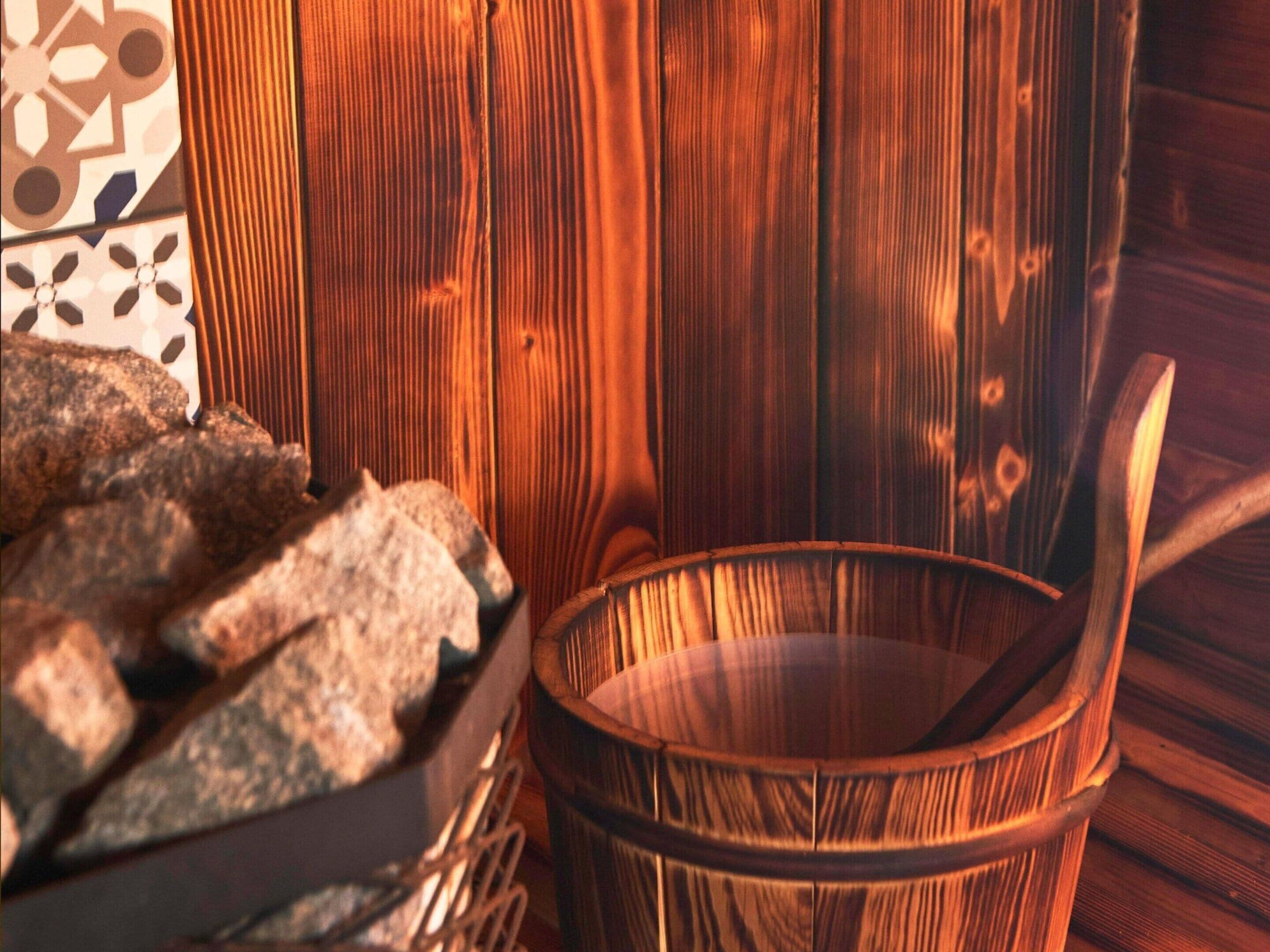 A wooden barrel, a woven basket, and a patterned wall.