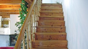 A wooden staircase with a railing, leading to an upper floor. - Cottage by Lake Dabrowa With Fishing (Dabrówno)