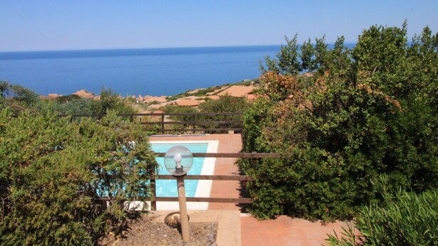 A view of a pool area with a clear blue sky and ocean in the background. - Terraced House With Communal Pool Costa Paradiso-formerly TUI Ferienhaus (Trinità d'Agultu e Vignola)