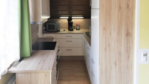 A compact kitchen with a microwave, coffee maker, and a small sink. - Apartment in St. Kanzian Near Klopeiner See (Sankt Kanzian am Klopeiner See)