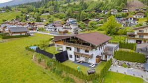A residential area with houses, a large building with a balcony, and a swimming pool. - Chalet in Neukirchen With Mountain Views (Neukirchen am Grossvenediger)