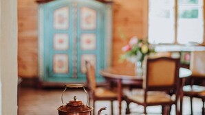 A rustic wooden interior with a vintage-style cabinet and a table with chairs. - Holiday Home in Belczna Near Klepnicko Lake (Łobez)