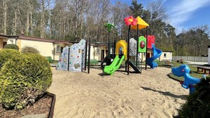 A playground with climbing structures, slides, and a sand area. - Single-story Holiday Homes Close to the Beach (gmina Sianów)