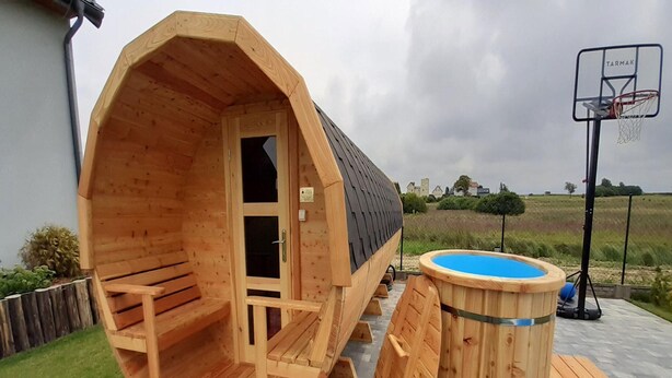 A wooden sauna with benches and a small pool area. - Large, 2-story Holiday Home, Sauna, Jacuzzi (Mielno)