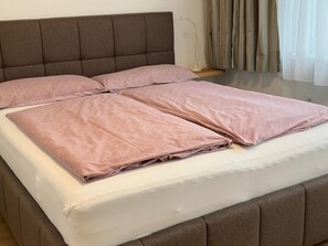 A bed with a headboard, pillows, and a blanket. - Apartment in Axams Near Axamer Lizum (Axams)