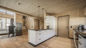 Una cocina moderna con armarios de madera, una isla central y un horno empotrado.
