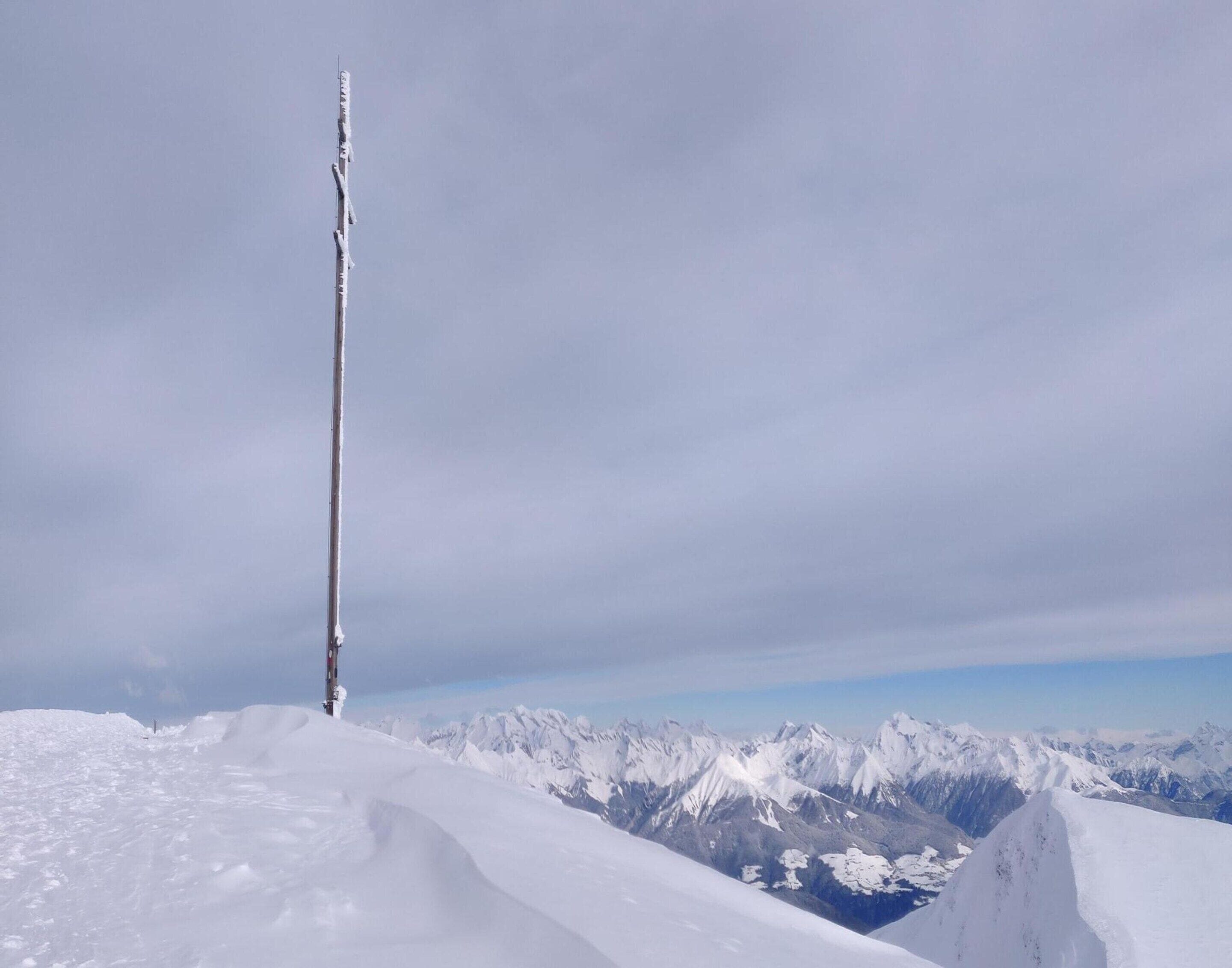 A snow-covered mountain peak with a clear sky.