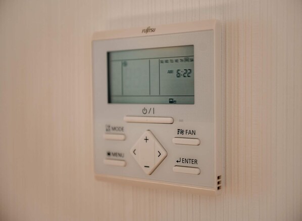 A control panel with a digital display, buttons labeled 'MENU,' 'MODE,' 'FAN,' and 'ENTER.'