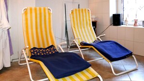 Two striped lounge chairs with cushions, a white towel rack, and a speaker on a windowsill. - Ferienwohnung, Tambach-dietharz (Tambach-Dietharz)
