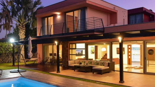 A modern two-story house with a swimming pool, outdoor seating area, and a balcony. - Villa With Private Pool in the Golf Resort (San Bartolomé de Tirajana)