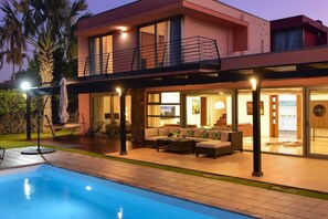 A modern two-story house with a swimming pool, outdoor seating area, and a balcony. - Villa With Private Pool in the Golf Resort (San Bartolomé de Tirajana)
