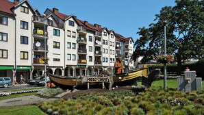 A row of multi-story residential buildings with balconies and satellite dishes. - Bungalow in Miedzyzdroje Near Baltic Beach (Miedzyzdroje)