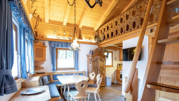 A rustic wooden interior with a dining area, benches, and a staircase. - Chalet in Austria Near Ski Lift & Forest (Wald im Pinzgau)