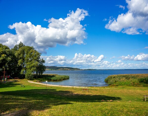 Un parc au bord du lac, doté d’un sentier pédestre, de bancs et d’une aire de jeux.