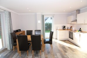 Enjoy meals at the dining table with oven and coffee maker.