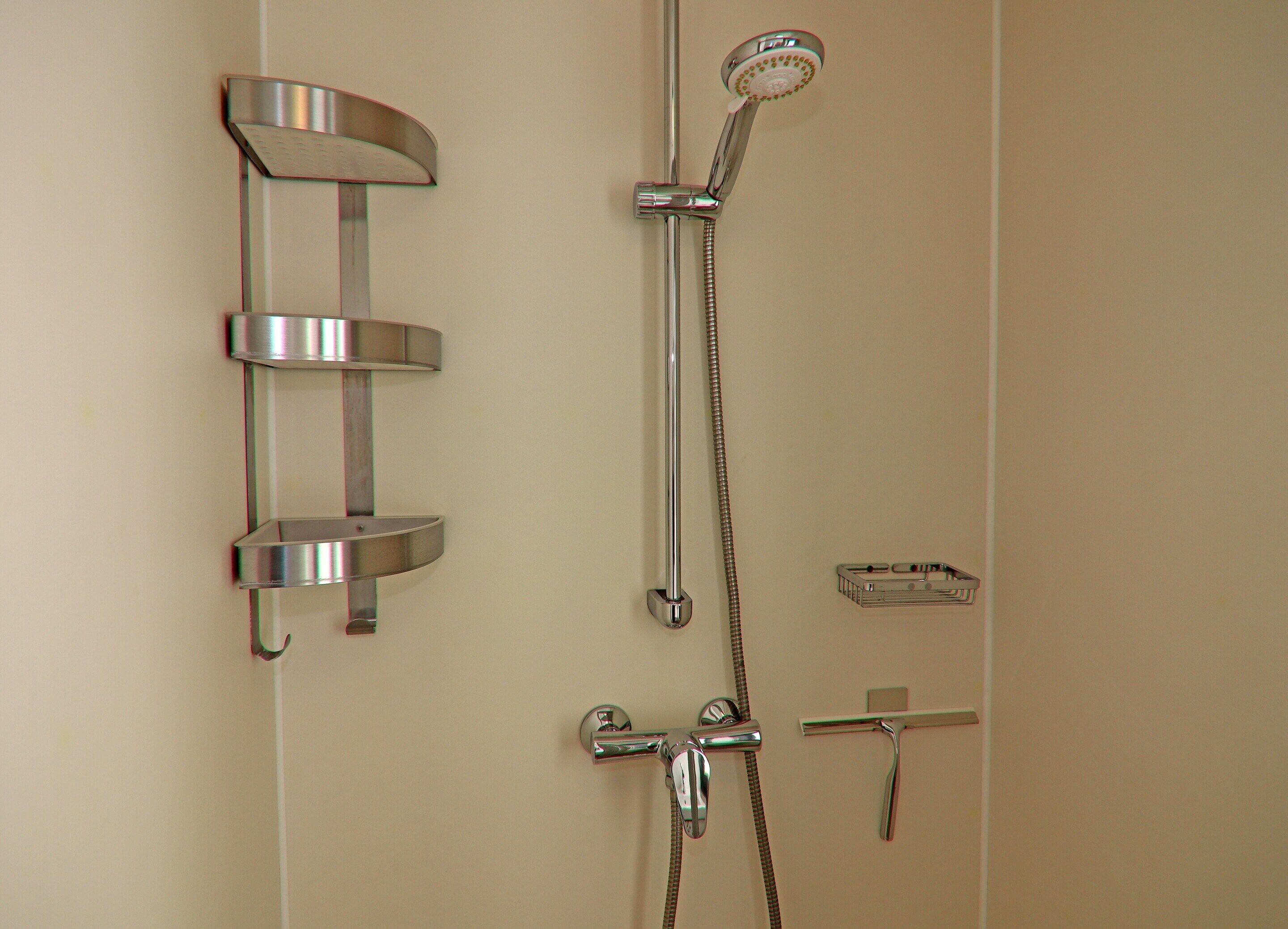 A bathroom with a shower, a toilet, and a sink.