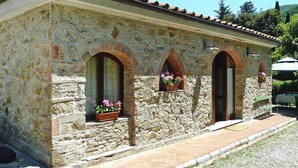A stone building with arched windows and a tiled roof. - Rustic House in Tuscany With Shared Pool (San Giuliano Terme)