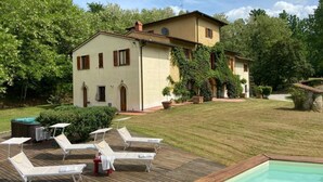 A house with a swimming pool, lounge chairs, and a hot tub. - Villa Privata "Forre 563 " (Reggello)