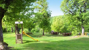 A park with a playground, picnic tables, and a covered seating area. - Tourist Resort, Grosseto (Sorano)