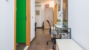 A hallway with a green door, a desk with a chair, a mirror, and a framed picture on the wall. - Apartment on Vir Island Near Sandy Beaches (Vir)