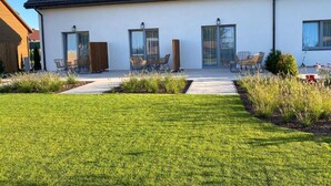 A modern two-story house with a flat roof, large windows, and a well-maintained lawn. - Holiday Home Grzybowo Near Beach & Bike Path (Kolobrzeg)