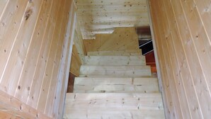 A wooden staircase with a handrail, leading to a lower level. - Holiday Home in Miedzyzdroje Near Baltic Sea (Międzyzdroje)