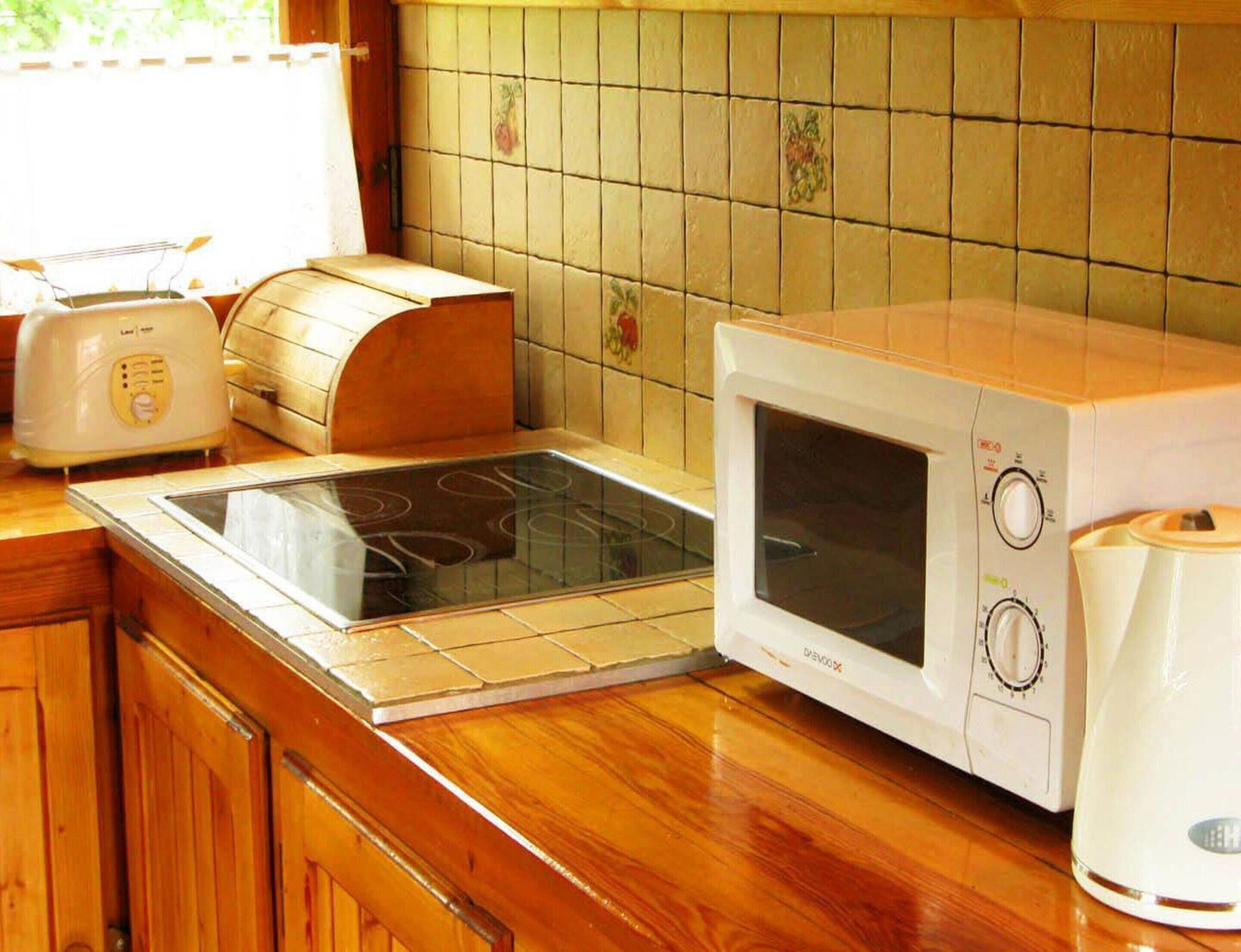A kitchen with a built-in stove, a microwave, and a toaster.