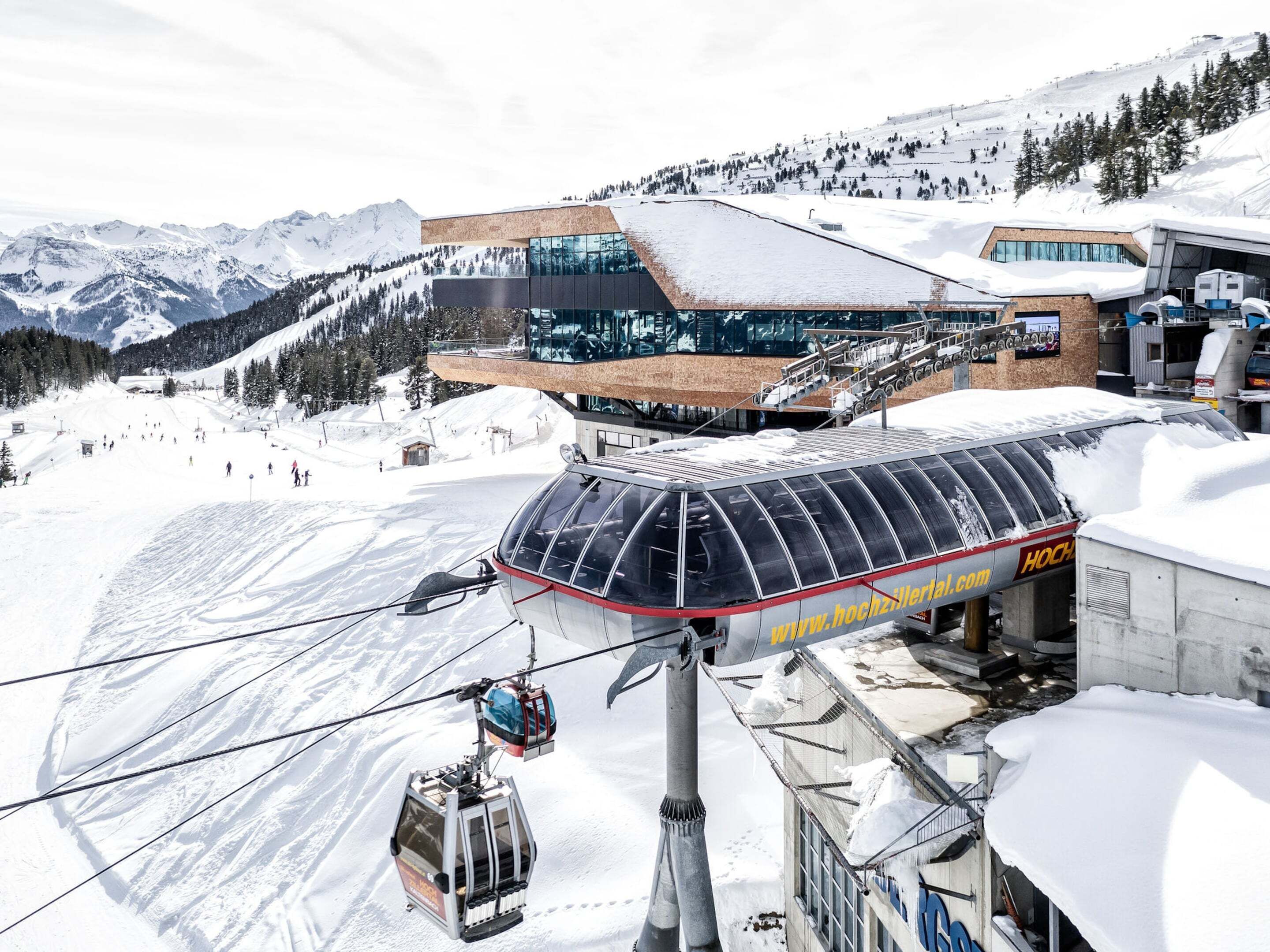A ski lift with a transparent canopy and a cable car system.