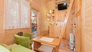 A wooden cabin interior with a sofa, a table, a TV, and a staircase. - Holiday Homes Near the Seaside Beach, Pobierowo (Rewal)