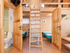A wooden cabin with a bathroom, a loft bedroom, and a lower bunk bed. - Holiday Homes Near the Seaside Beach, Pobierowo (Rewal)