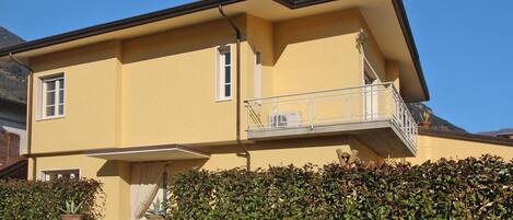 A two-story building with a balcony on the upper floor.