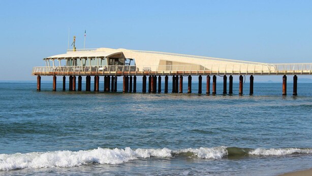 A pier extending into the water with a covered seating area and a flagpole. - Villa in Camaiore Near Sandy Beaches (Camaiore)