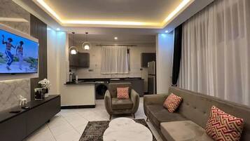 Luxury Apartment, Balcony, City View | Living area | Flat-screen TV