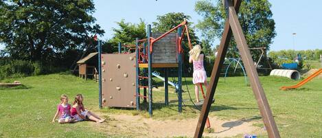 A playground with climbing structures and a slide.