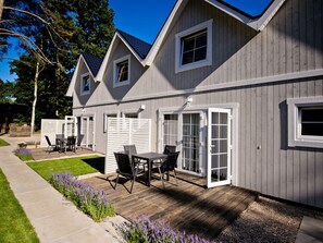 A modern house with a patio, outdoor seating, and a well-maintained lawn. - Holiday Home in Pobierowo Near Baltic Beach (Rewal)