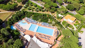 An aerial view of a resort with multiple swimming pools, sun loungers, and lush greenery. - Resort Riva Degli Etruschi, San Vincenzo (San Vincenzo)
