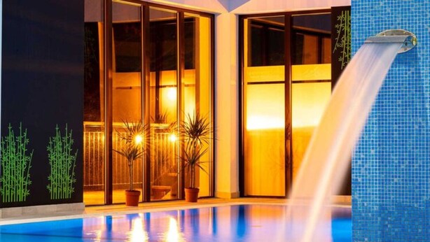 A pool area with a waterfall feature, indoor lighting, and potted plants. - Apartment With a View, Pool, Szklarska Poreba (Szklarska Poreba)