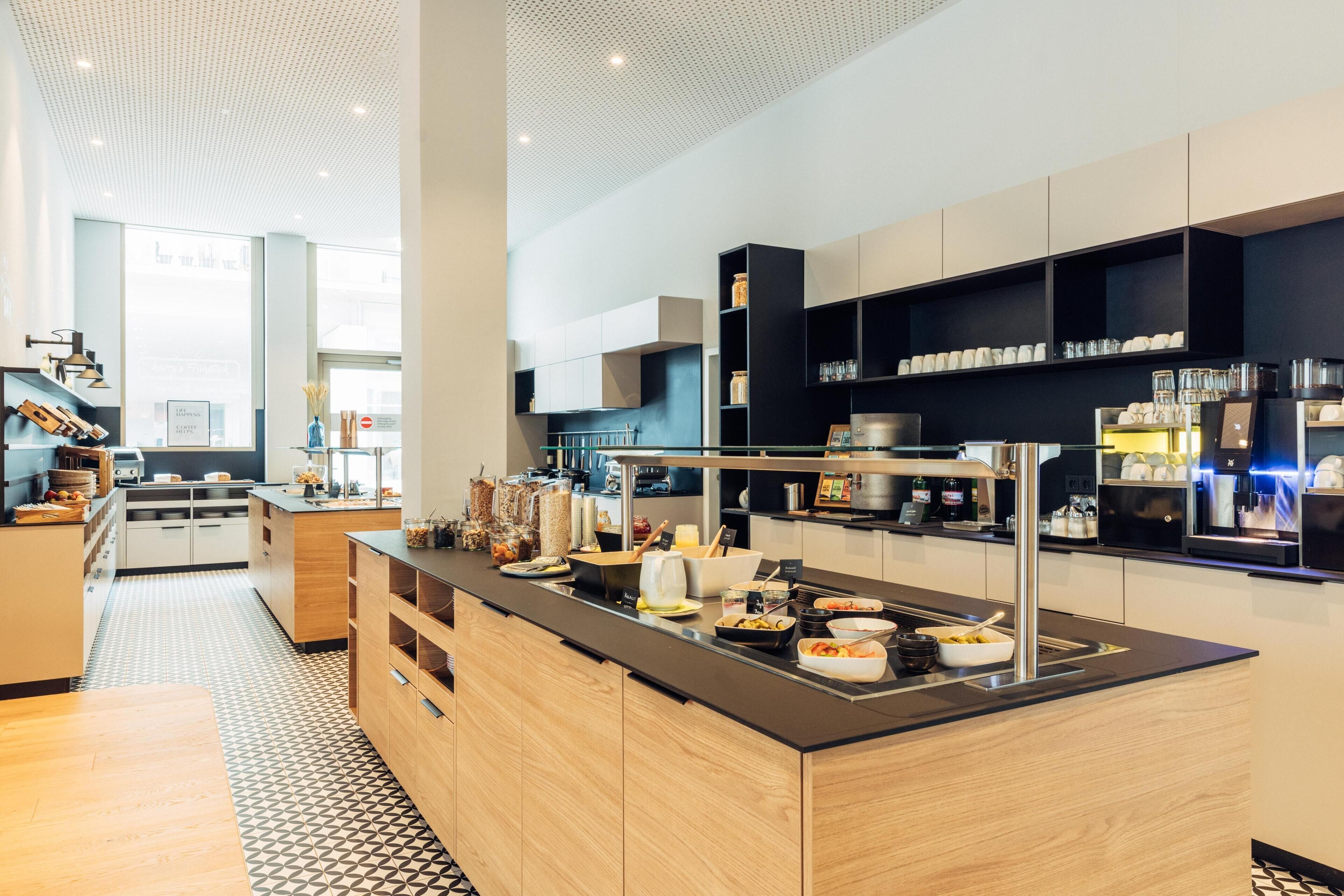 Una cocina moderna con una isla central, electrodomésticos integrados y una variedad de alimentos.