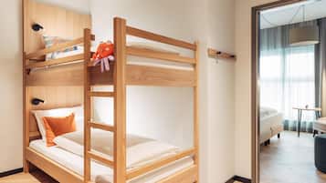 A bunk bed with a wooden frame, white bedding, and a plush toy on the top bunk.
