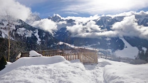 A snow-covered mountain landscape with a wooden fence in the foreground. - Chalet in Funes Valley With Dolomites Views (Funes)
